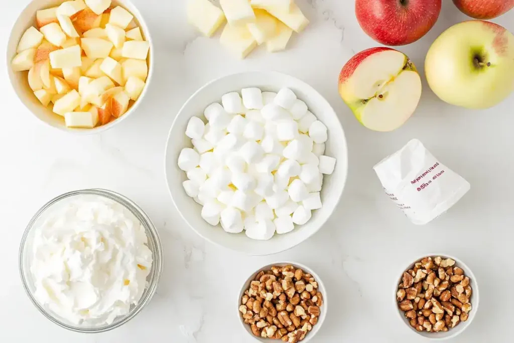 Ingredients for Taffy Apple Salad on a marble surface.